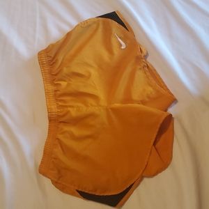 Orange Nike running shorts